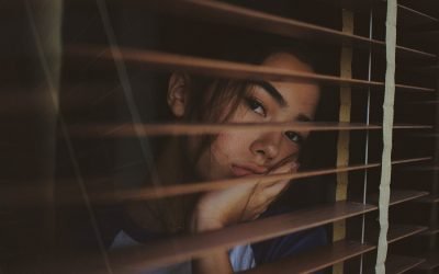 Depressed woman looking out a window