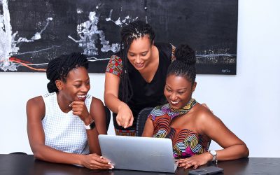 three women looking at the computer