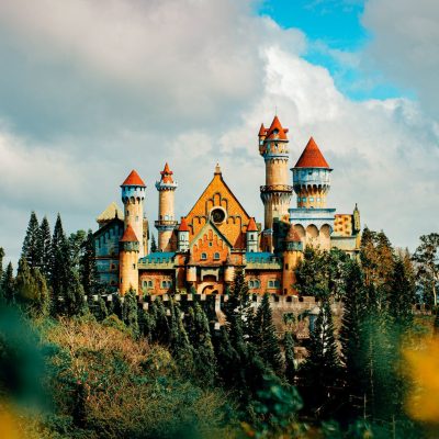 castle facade in theme park under cloudy sky